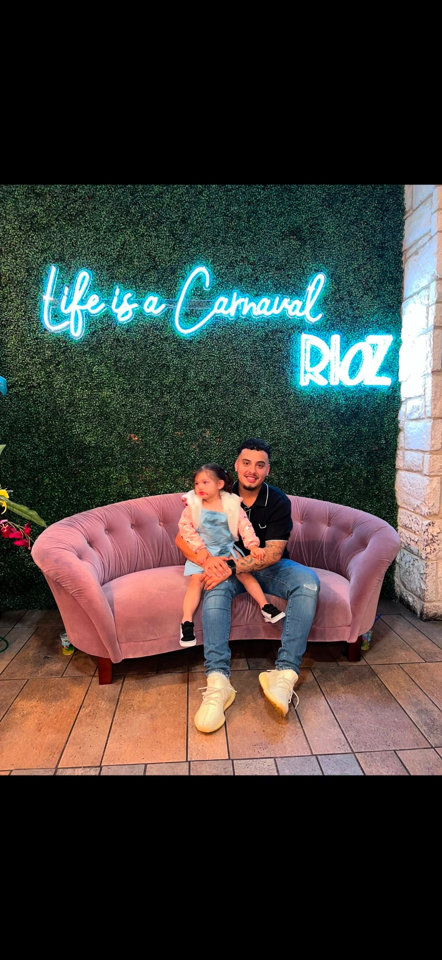 Father and daughter on the pink couch